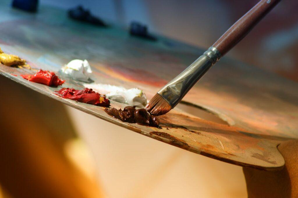 pexels-photo-102127 Vibrant artist palette with paint and brush creating colorful artwork.